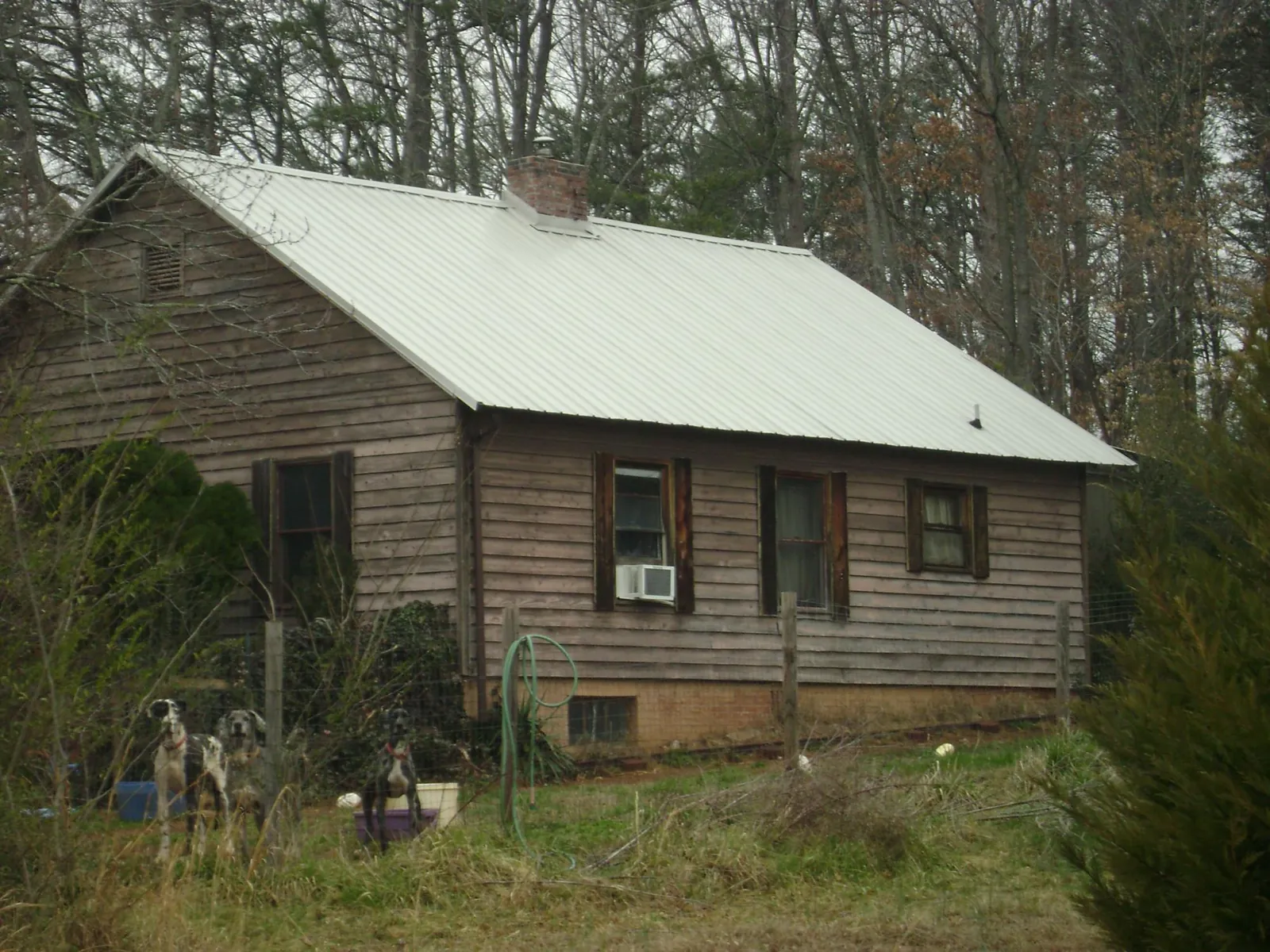 White metal roof on an old wood sided farmhouse, from a Metal Roof Installation job in Evans City
